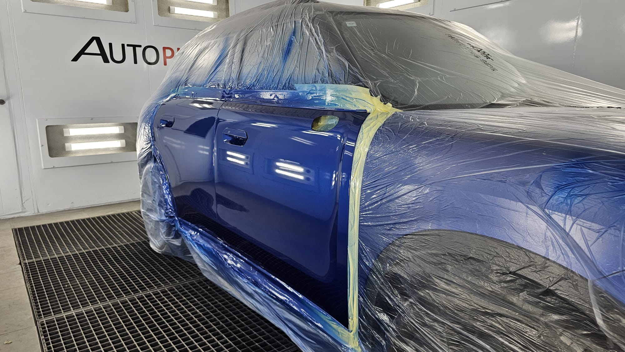 Blue KGM SUV side panels refinished in the Autophix paint booth