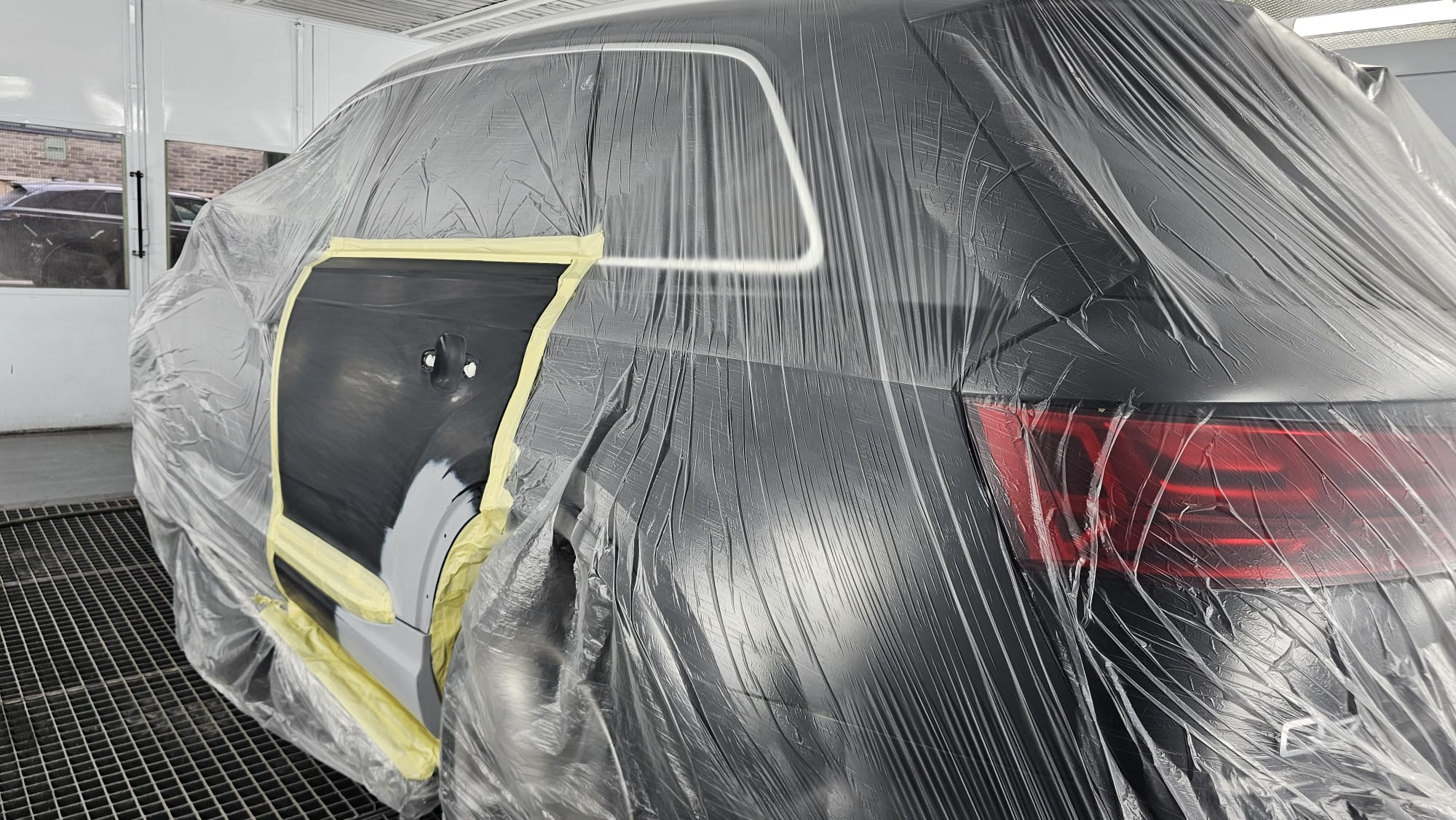 Audi Q7 rear door prepared for panel repair and refinishing