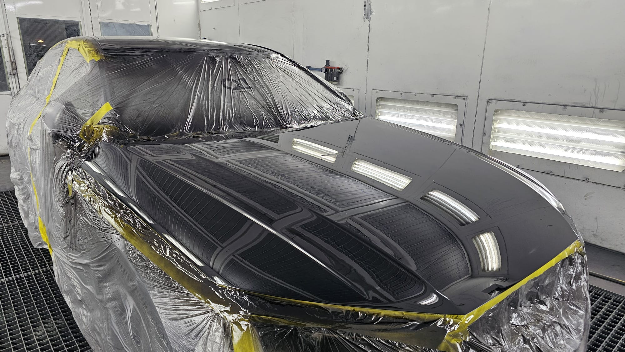 Glossy finished vehicle paintwork under controlled lighting at Autophix