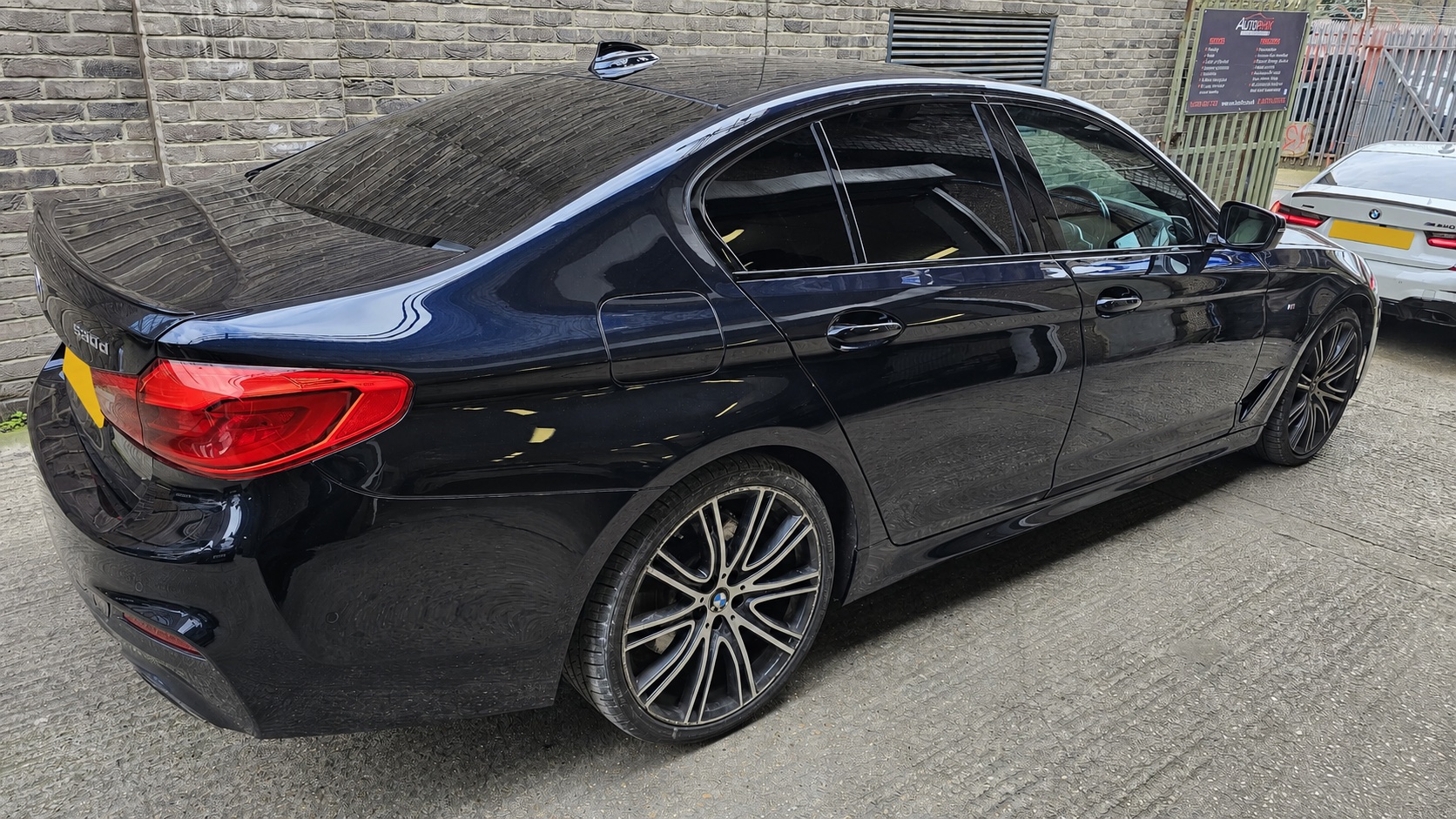 Dark BMW 530d after Autophix rear-quarter repair and paint refinishing