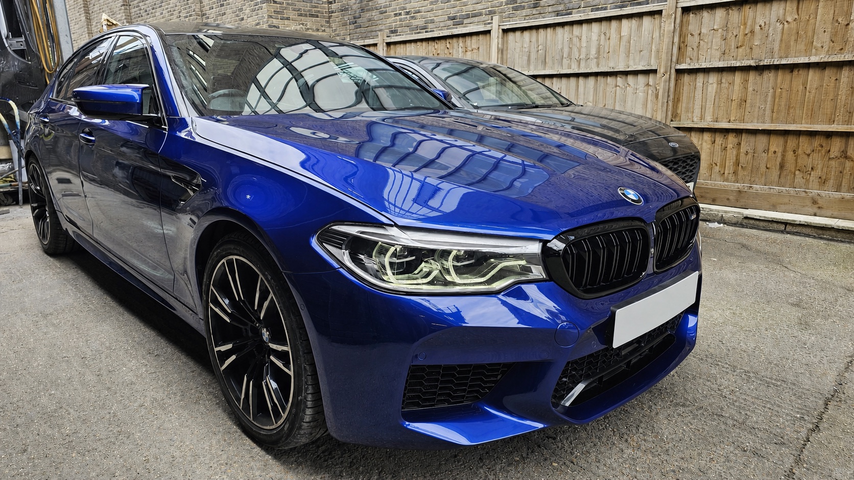 Blue BMW M5 after Autophix bumper repair and paint refinishing